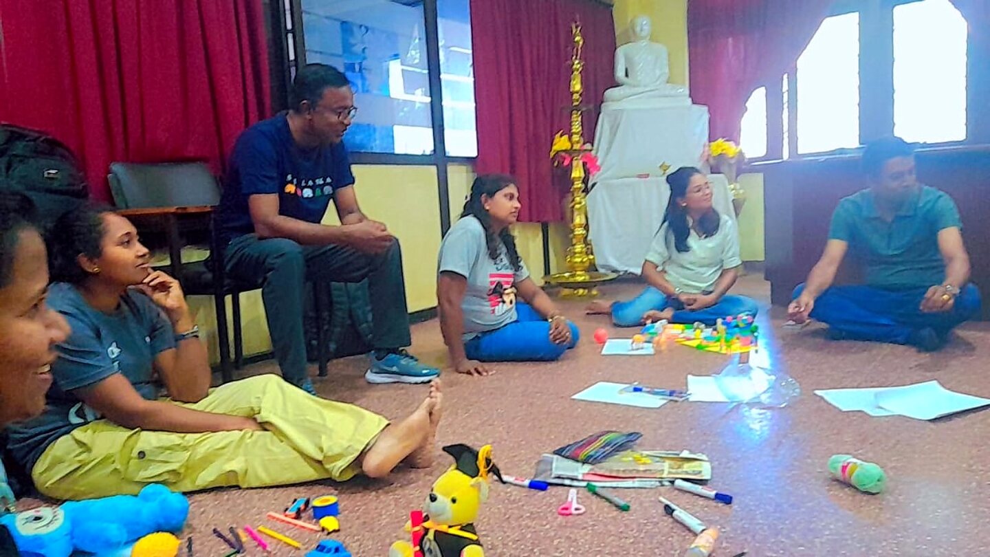 Facilitated group reflection with therapeutic play materials